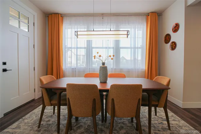 a view of a dining room with furniture window and wooden floor