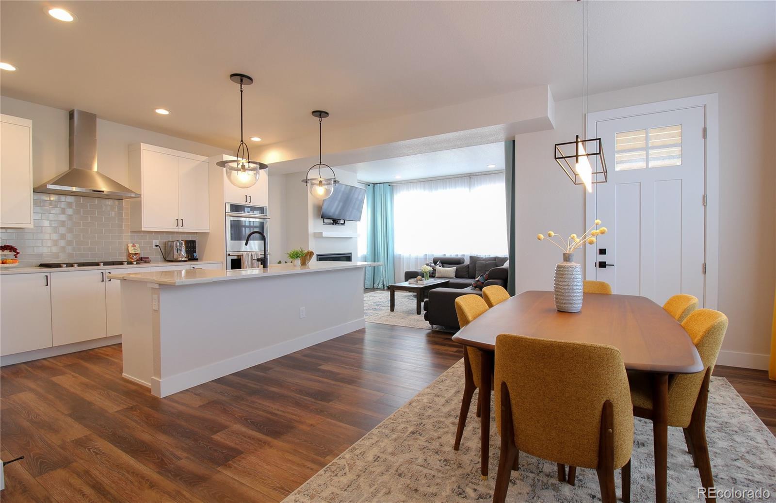 10394 Detroit Street Denver, CO 80229 - Photo 8 of 50 a dining table chairs and a kitchen view