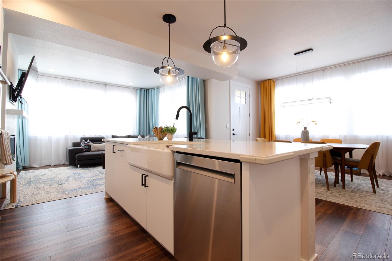 10394 Detroit Street Denver, CO 80229 - Photo 10 of 50 a kitchen with a sink cabinets and window