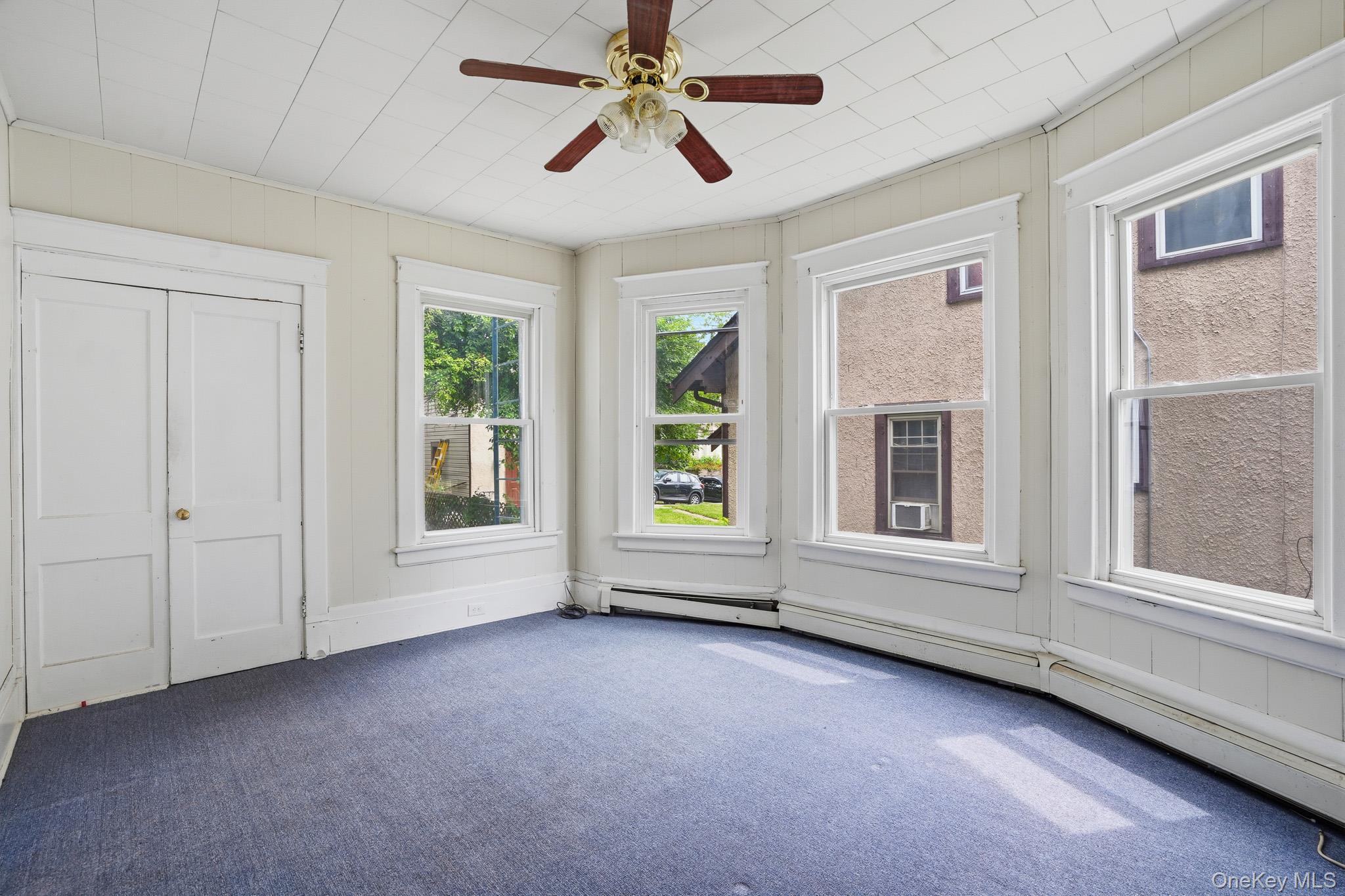 65 North Clinton Street Poughkeepsie, NY 12601 - Photo 15 of 43 an empty room with chandelier fan and windows