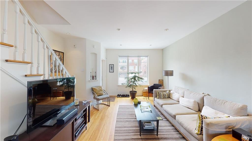 83 Gravesend Neck Road Brooklyn, NY 11223 - Photo 11 of 27 a living room with furniture and a fireplace