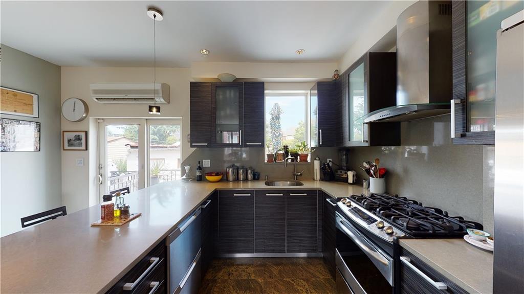 83 Gravesend Neck Road Brooklyn, NY 11223 - Photo 12 of 27 a kitchen with stainless steel appliances a stove a sink a stove and a refrigerator