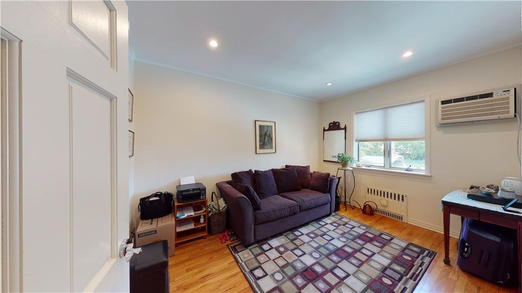 83 Gravesend Neck Road Brooklyn, NY 11223 - Photo 15 of 27 a living room with furniture and a window
