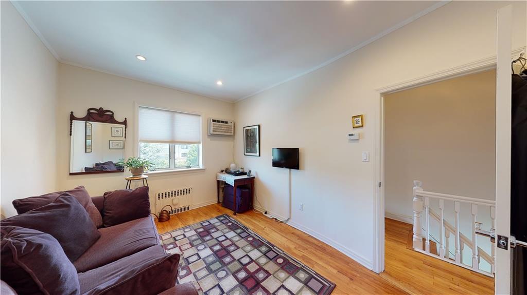 83 Gravesend Neck Road Brooklyn, NY 11223 - Photo 16 of 27 a living room with furniture and a window