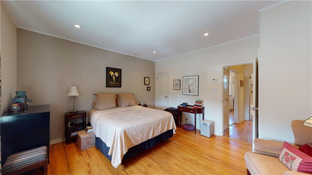 83 Gravesend Neck Road Brooklyn, NY 11223 - Photo 18 of 27 a bedroom with a bed and wooden floor