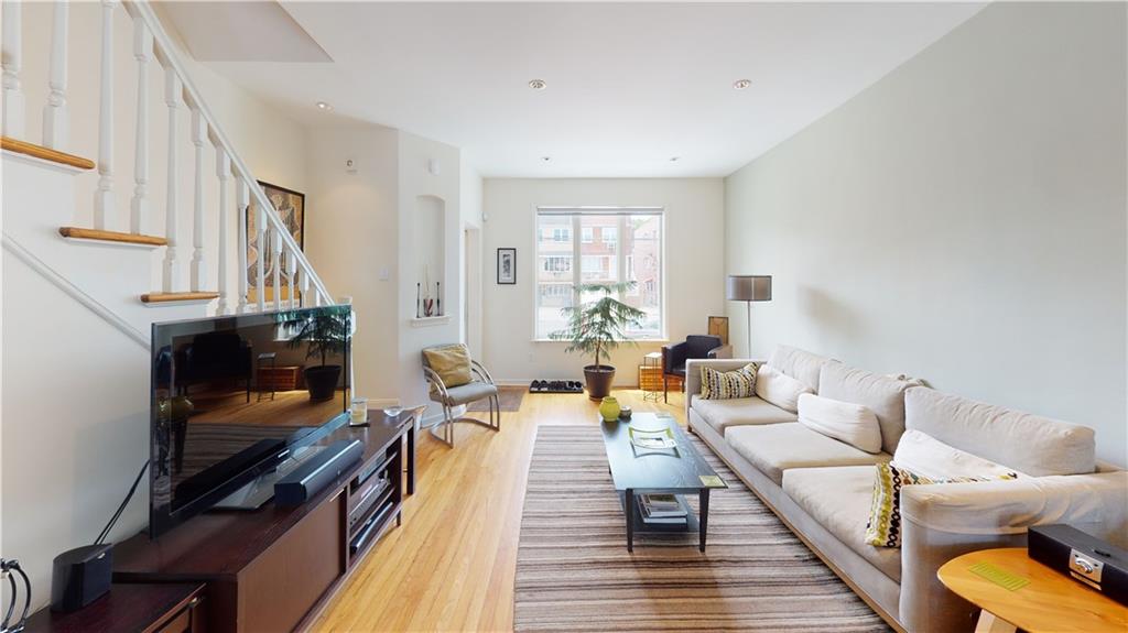 83 Gravesend Neck Road Brooklyn, NY 11223 - Photo 23 of 27 a living room with furniture and a fireplace