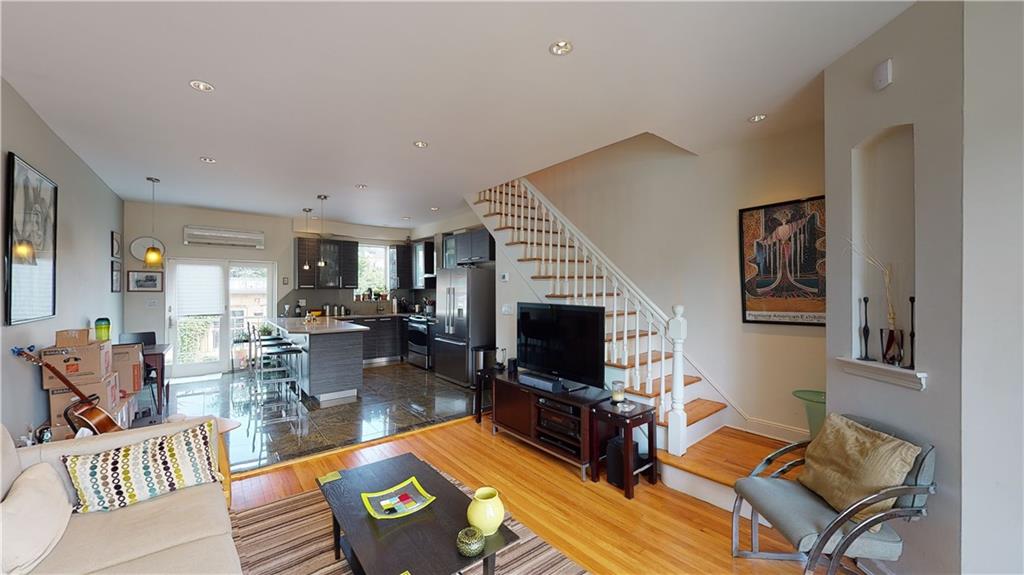 83 Gravesend Neck Road Brooklyn, NY 11223 - Photo 24 of 27 a living room with furniture a flat screen tv and a fireplace