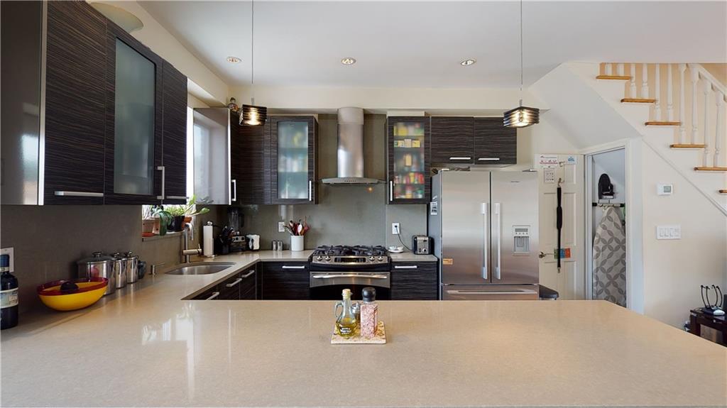 83 Gravesend Neck Road Brooklyn, NY 11223 - Photo 25 of 27 a kitchen with stainless steel appliances a sink a stove and refrigerator