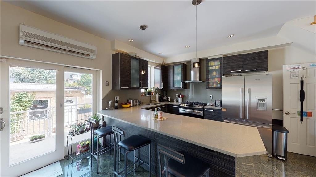 83 Gravesend Neck Road Brooklyn, NY 11223 - Photo 26 of 27 a kitchen with a table chairs refrigerator and cabinets
