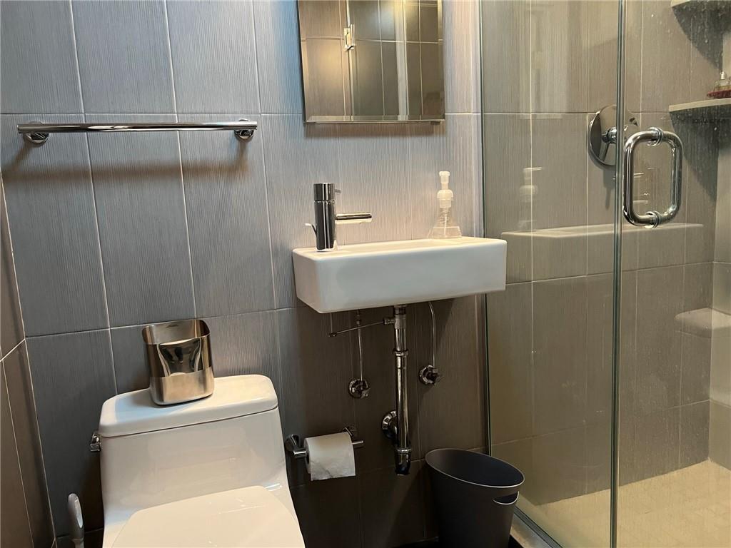 83 Gravesend Neck Road Brooklyn, NY 11223 - Photo 5 of 27 a bathroom with a toilet a sink and shower