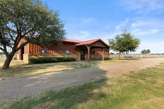 a front view of a house with a yard and ocean view