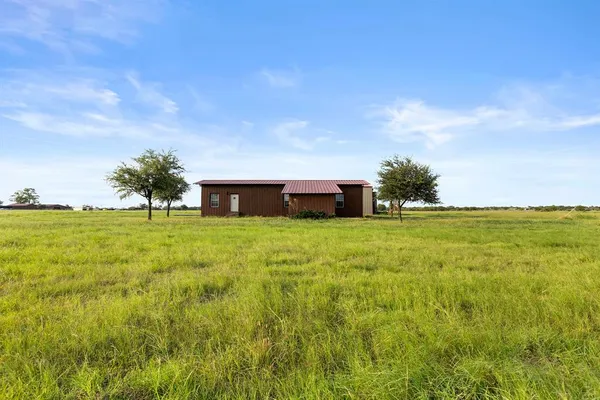 a view of an house with backyard space and trampoline