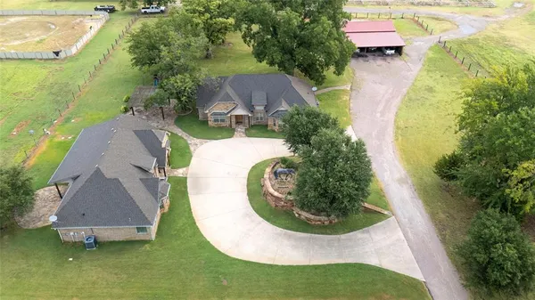 an aerial view of a house with swimming pool outdoor seating and yard