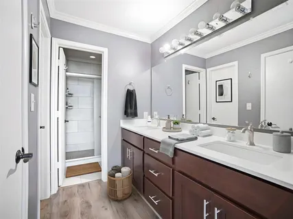 a bathroom with a double vanity sink and a mirror
