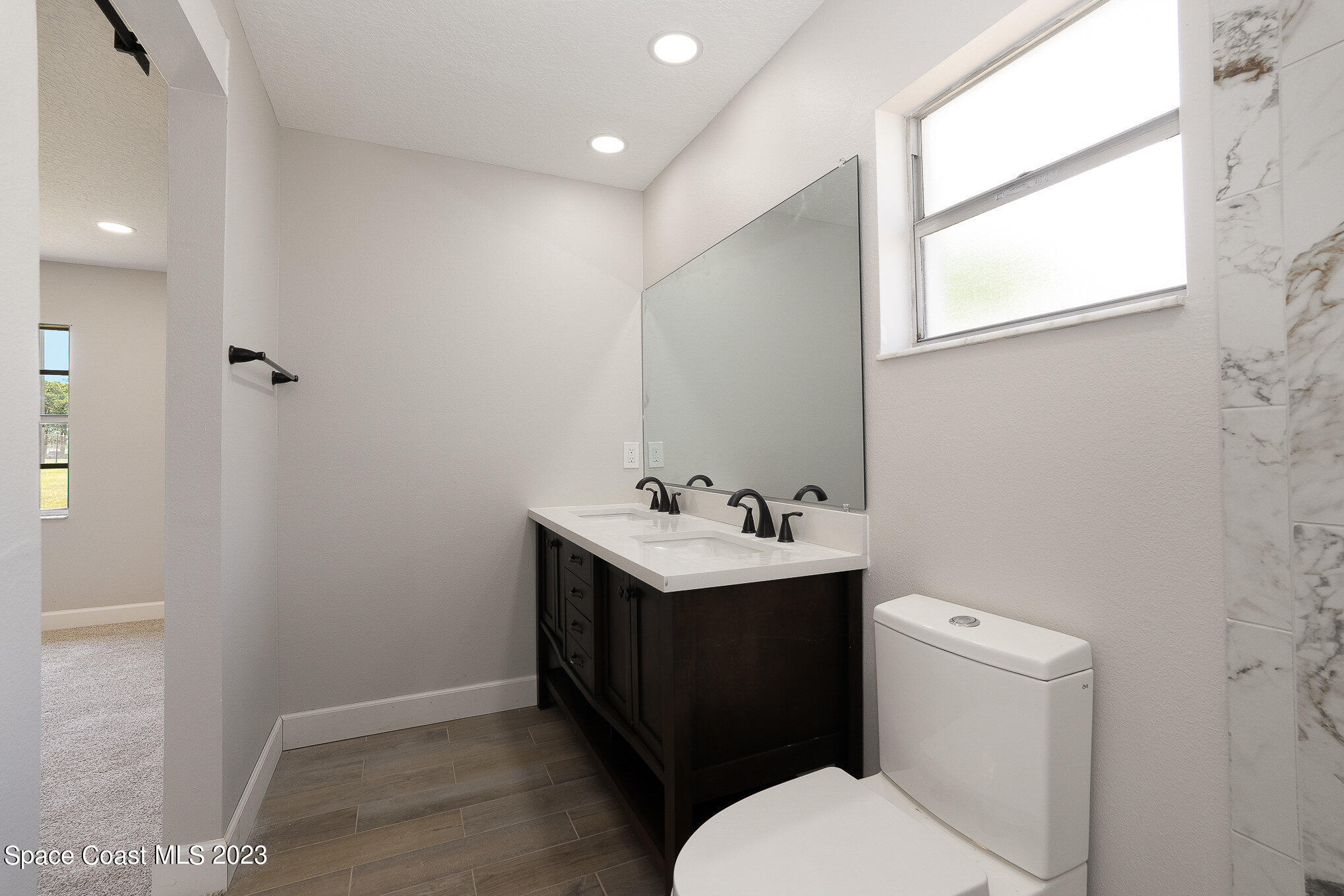 1339 Forest Drive Rockledge, FL 32955 - Photo 15 of 21 a bathroom with a toilet sink and mirror