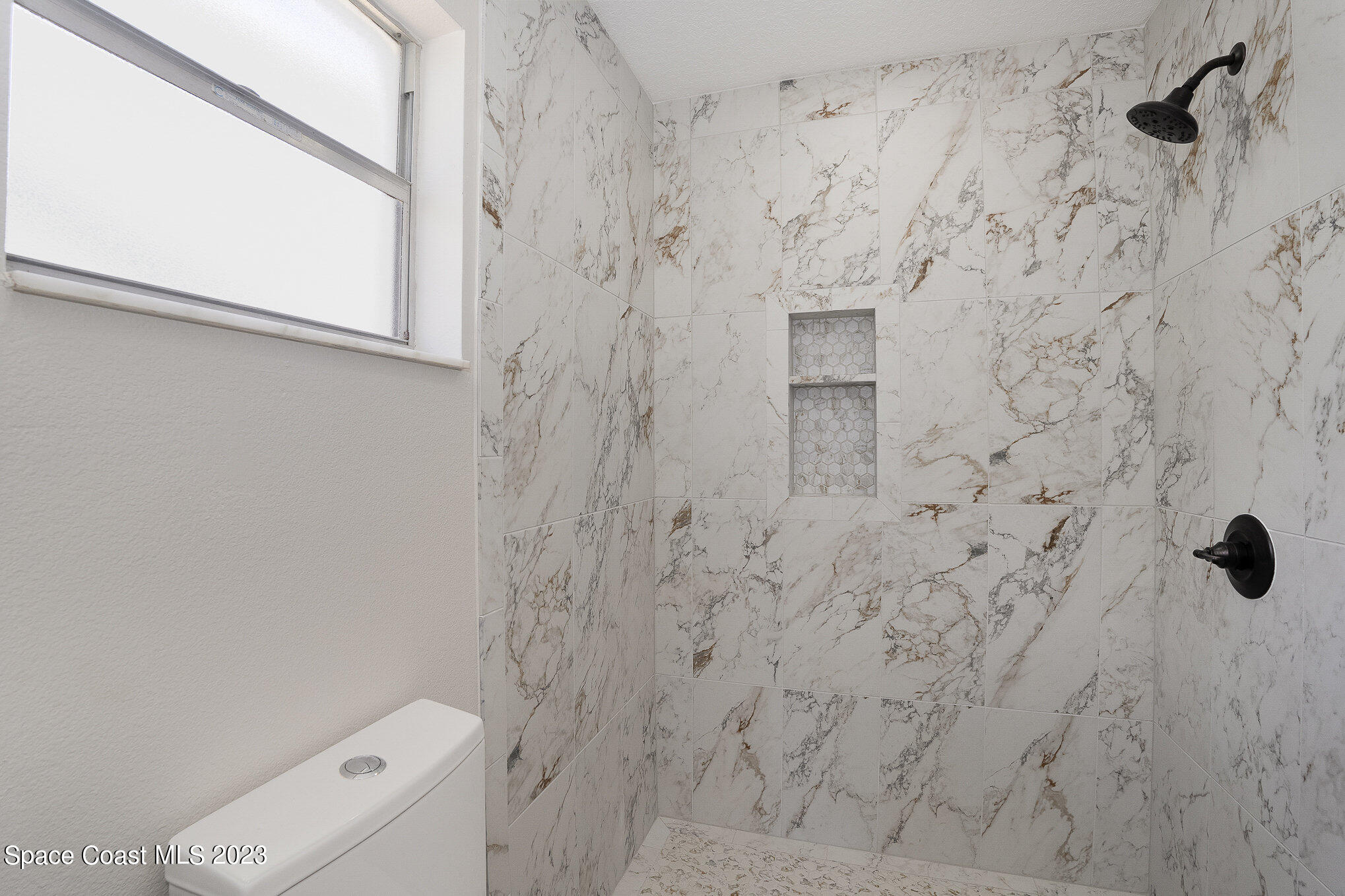 1339 Forest Drive Rockledge, FL 32955 - Photo 16 of 21 a bathroom with a shower and a toilet