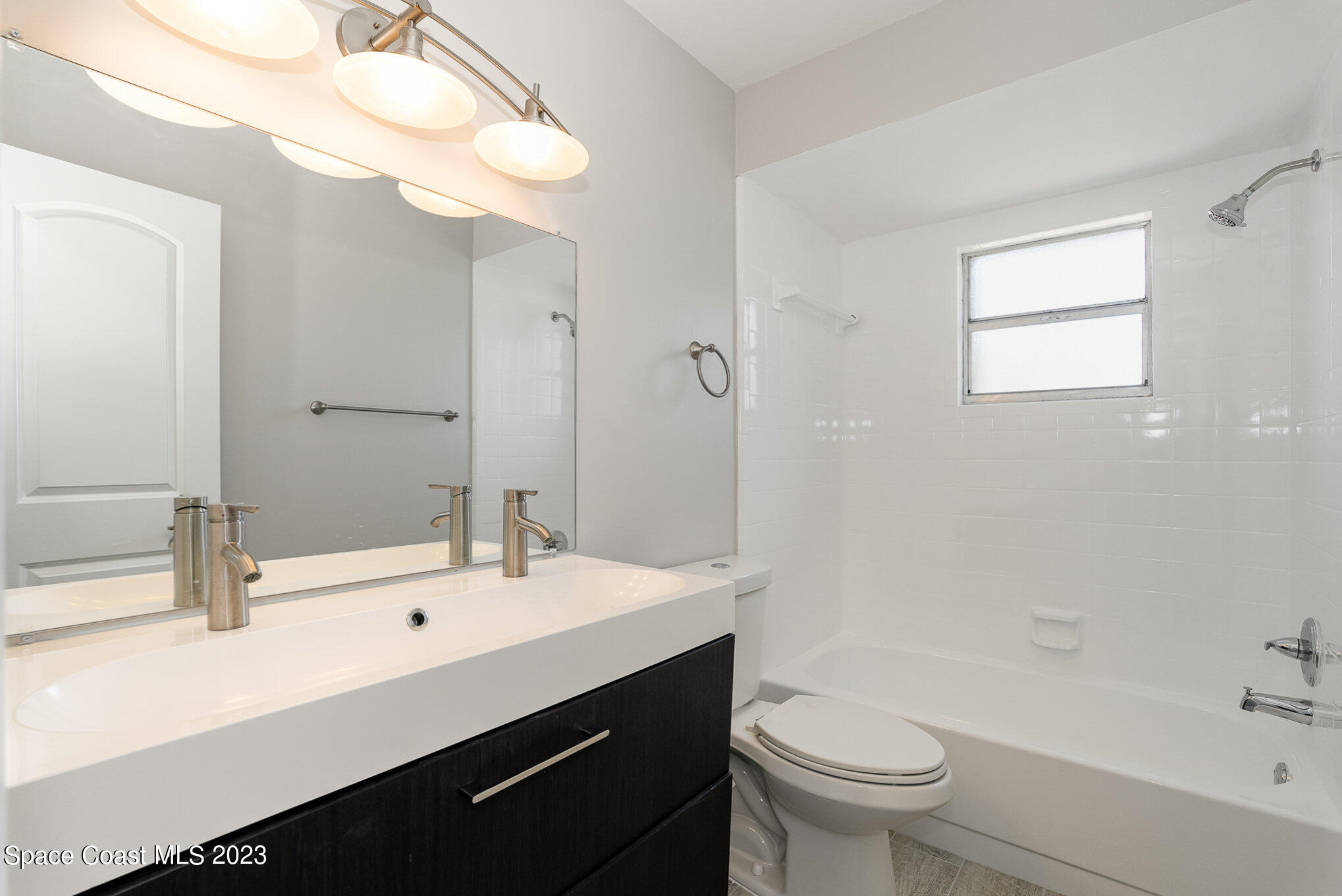 1339 Forest Drive Rockledge, FL 32955 - Photo 17 of 21 a bathroom with a sink a toilet and a bathtub