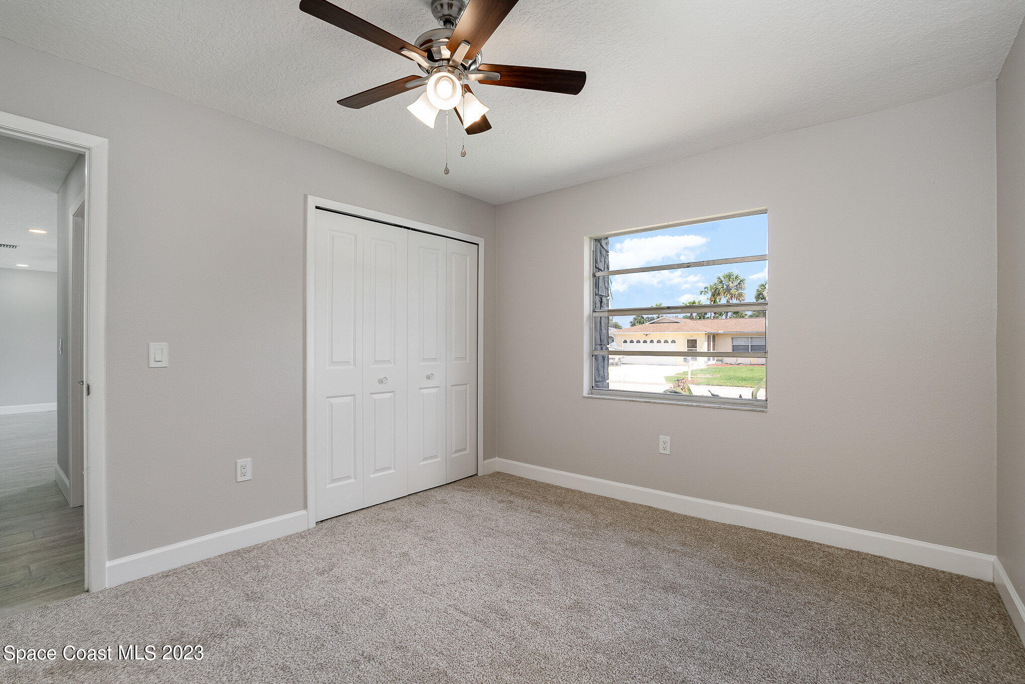 1339 Forest Drive Rockledge, FL 32955 - Photo 18 of 21 an empty room with windows and fan