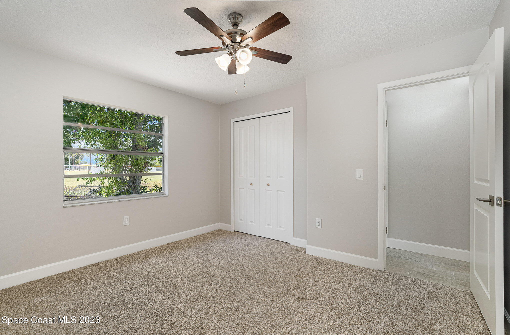 1339 Forest Drive Rockledge, FL 32955 - Photo 19 of 21 an empty room with a window and a fan