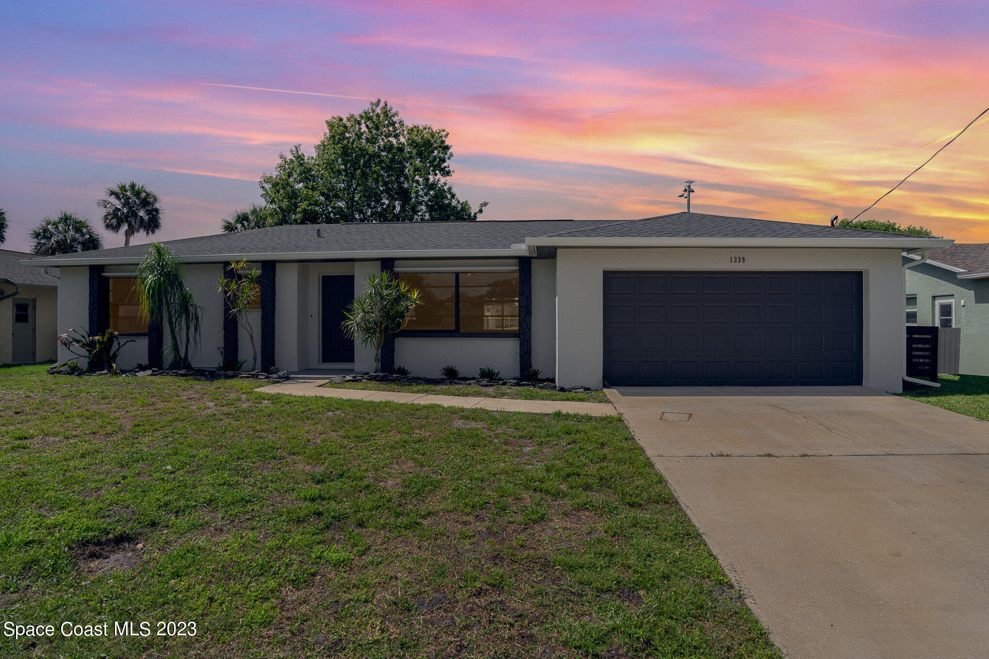 1339 Forest Drive Rockledge, FL 32955 - Photo 2 of 21 front view of a house with a yard