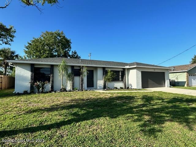 1339 Forest Drive Rockledge, FL 32955 - Photo 3 of 21 a front view of a house with a garden