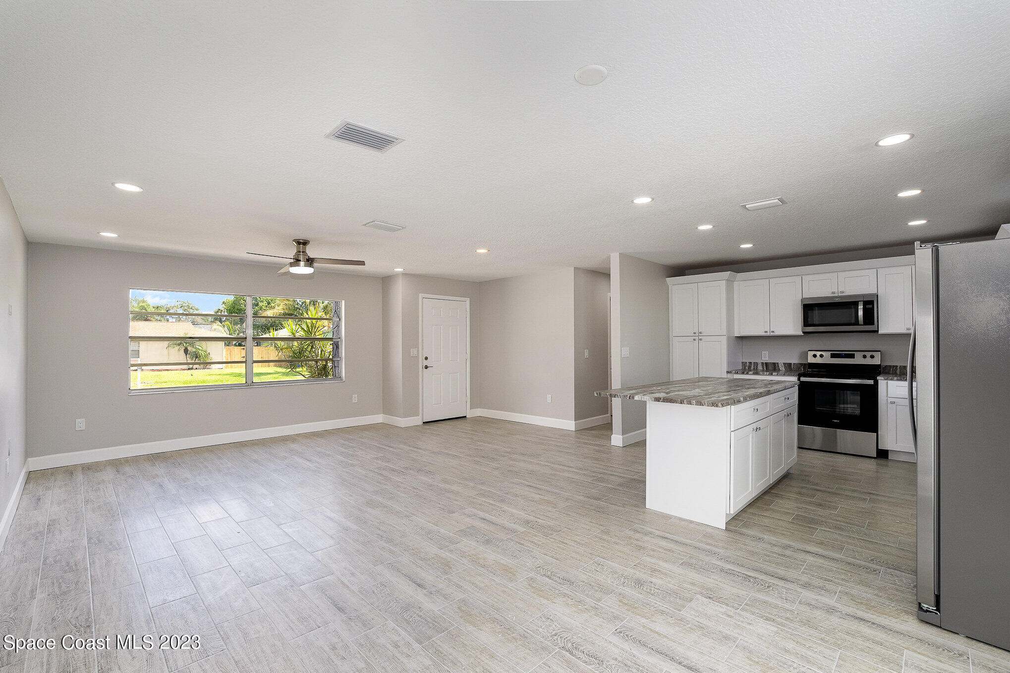 1339 Forest Drive Rockledge, FL 32955 - Photo 4 of 21 a view of kitchen with stove and refrigerator