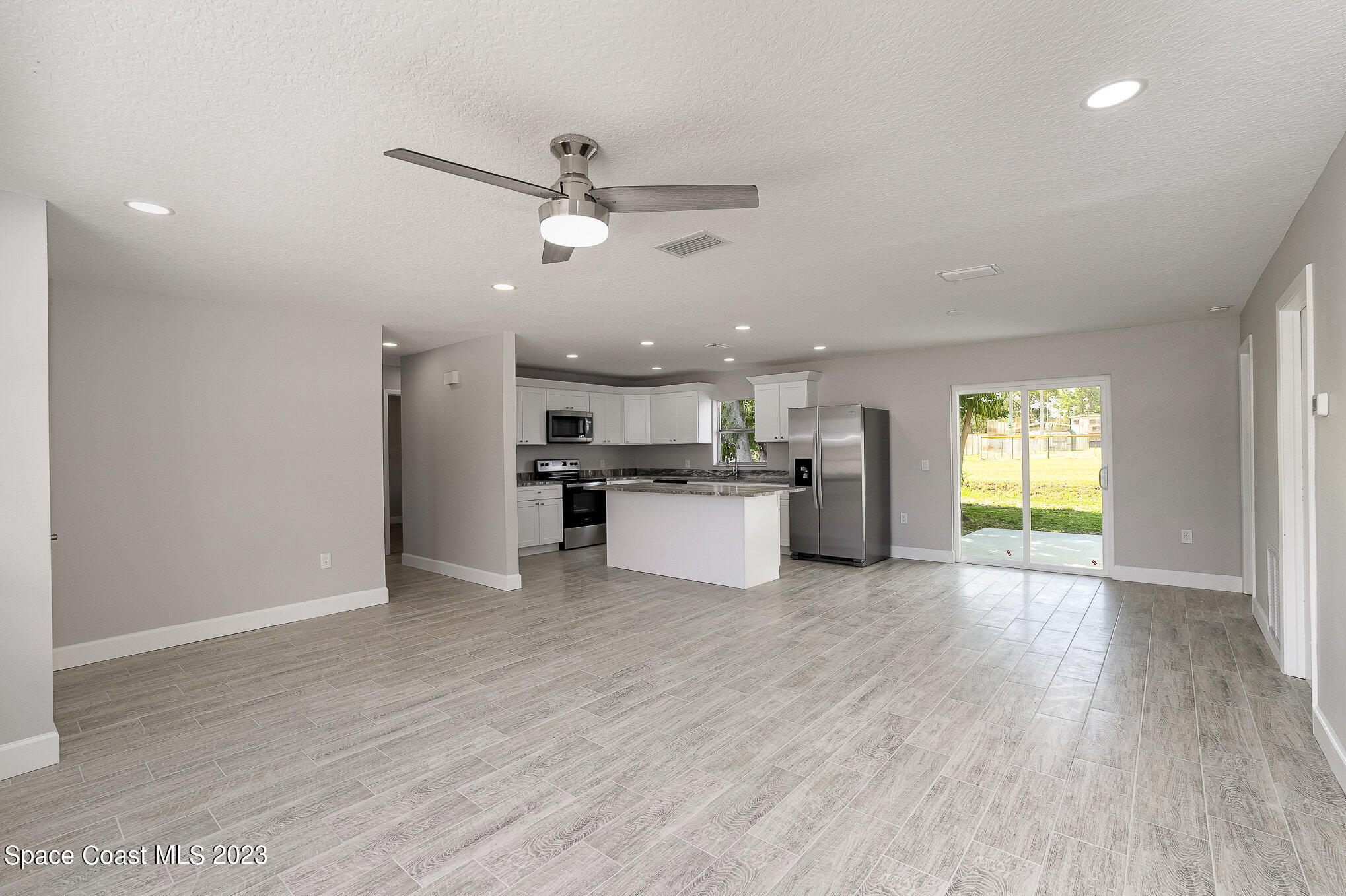 1339 Forest Drive Rockledge, FL 32955 - Photo 7 of 21 a view of kitchen with microwave and window
