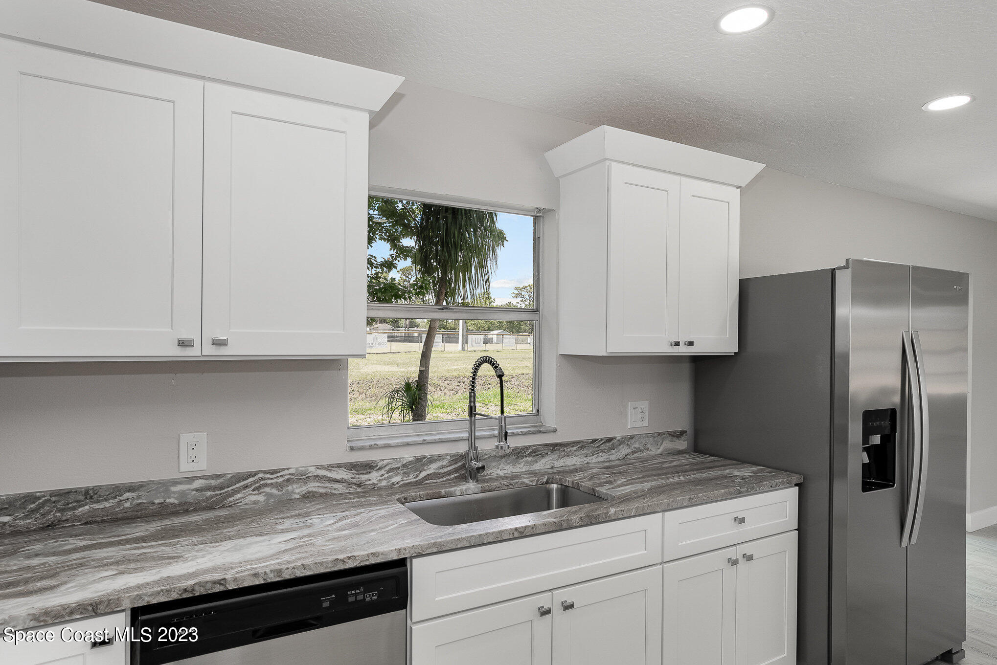 1339 Forest Drive Rockledge, FL 32955 - Photo 9 of 21 a kitchen with appliances a sink and cabinets