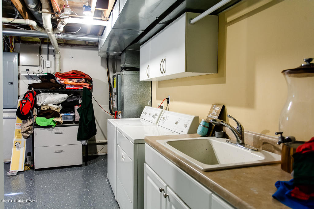 4314 Old Springdale Road Louisville, KY 40241 - Photo 28 of 38 Above the washer and dryer is built-in cabinetry with hanging rack for sorting and organization