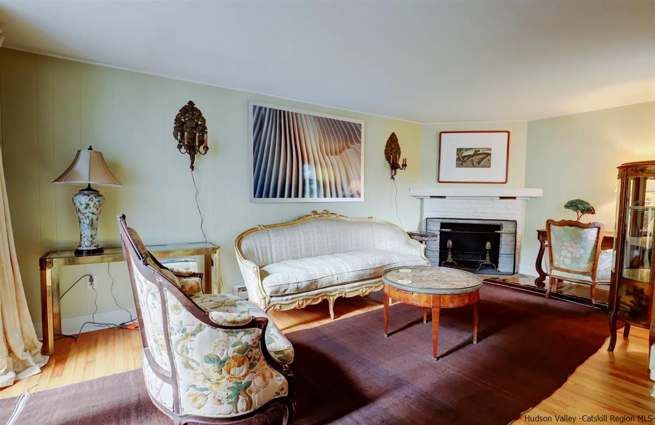 3572 Main Street Stone Ridge, NY 12484 - Photo 12 of 35 a living room with furniture a fireplace and a table