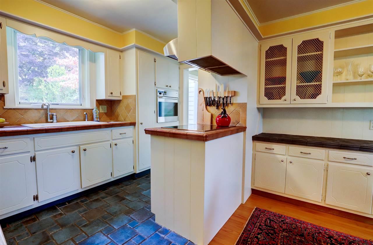 3572 Main Street Stone Ridge, NY 12484 - Photo 18 of 35 a kitchen with stainless steel appliances granite countertop a sink and cabinets with wooden floor