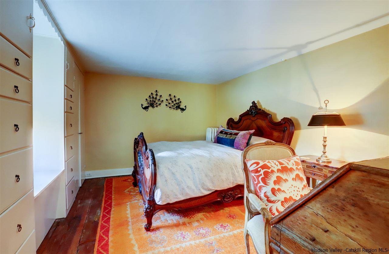 3572 Main Street Stone Ridge, NY 12484 - Photo 21 of 35 a bedroom with a bed and wooden floor