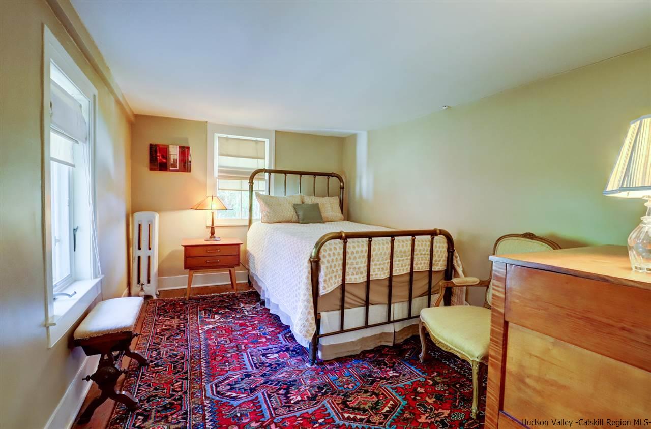 3572 Main Street Stone Ridge, NY 12484 - Photo 22 of 35 a bedroom with a bed and wooden floor