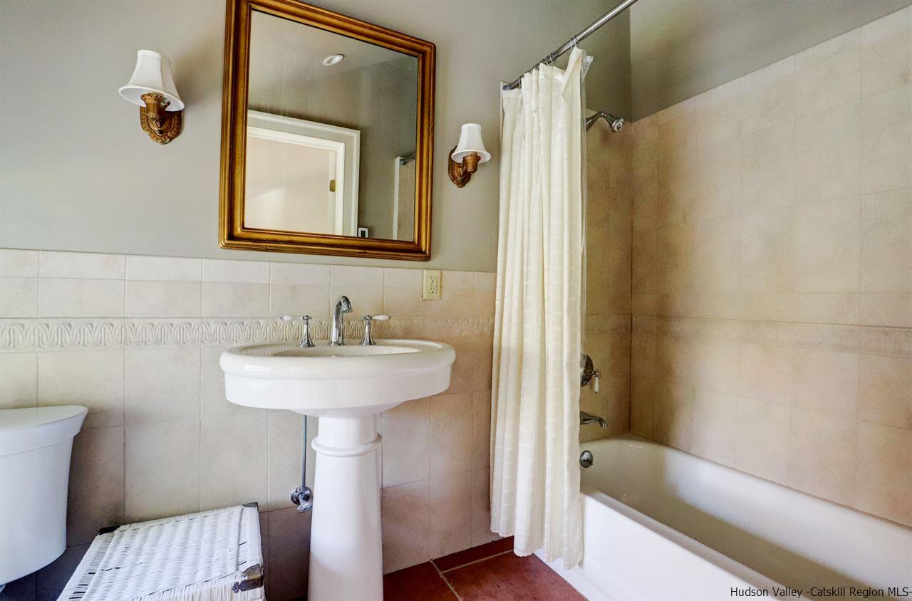 3572 Main Street Stone Ridge, NY 12484 - Photo 32 of 35 a bathroom with a sink a mirror and a bathtub