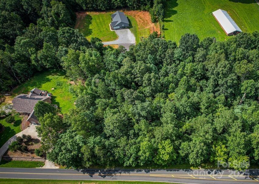 an aerial view of a house with yard swimming pool and outdoor seating