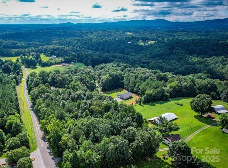 3994 Seitz Road Morganton, NC 28655 - Photo 2 of 9 a view of a garden with a building in the background