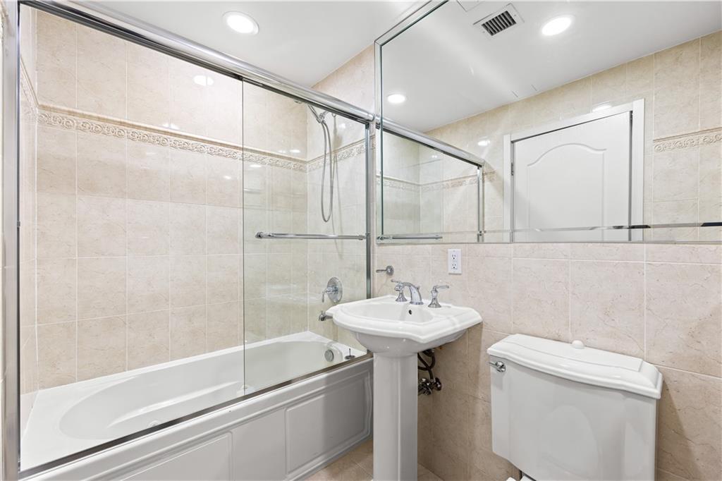 3165 Emmons Avenue, Unit PH3N Brooklyn, NY 11235 - Photo 12 of 33 a bathroom with a sink toilet and shower