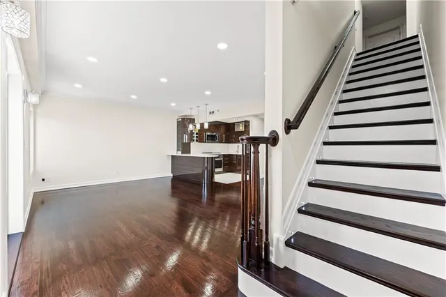 a view of entryway and hall with wooden floor