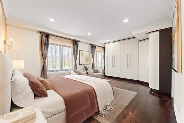 a spacious bedroom with a bed and a window