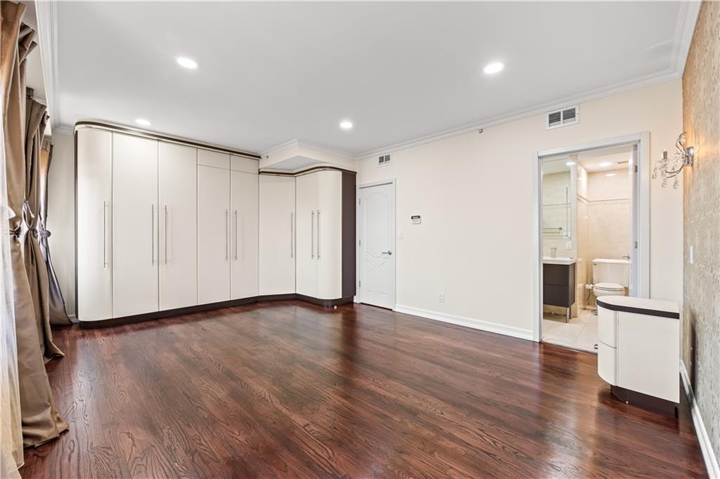 3165 Emmons Avenue, Unit PH3N Brooklyn, NY 11235 - Photo 22 of 33 a view of an empty room with wooden floor and a window