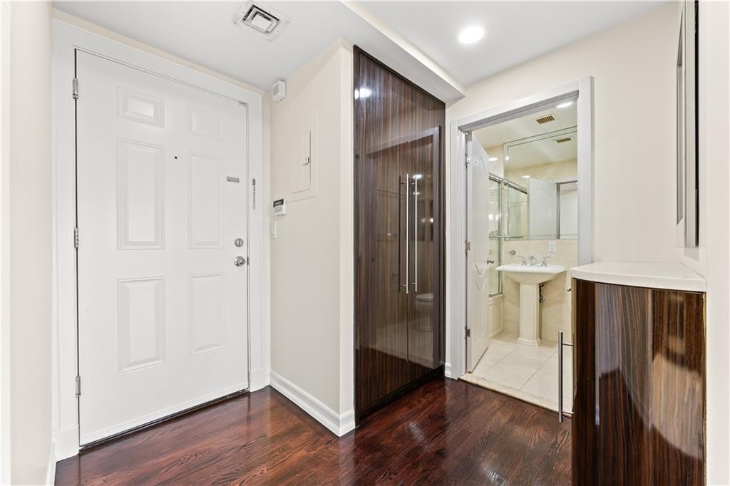 3165 Emmons Avenue, Unit PH3N Brooklyn, NY 11235 - Photo 3 of 33 a view of a hallway with wooden floor and cabinets in a room