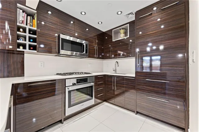 a kitchen with stainless steel appliances granite countertop cabinets and stove