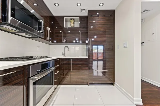 a kitchen with granite countertop a refrigerator and a stove