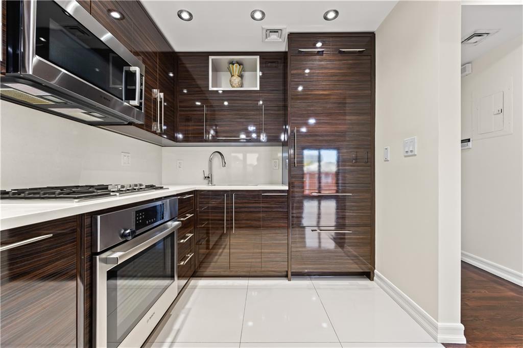 3165 Emmons Avenue, Unit PH3N Brooklyn, NY 11235 - Photo 9 of 33 a kitchen with granite countertop a refrigerator and a stove