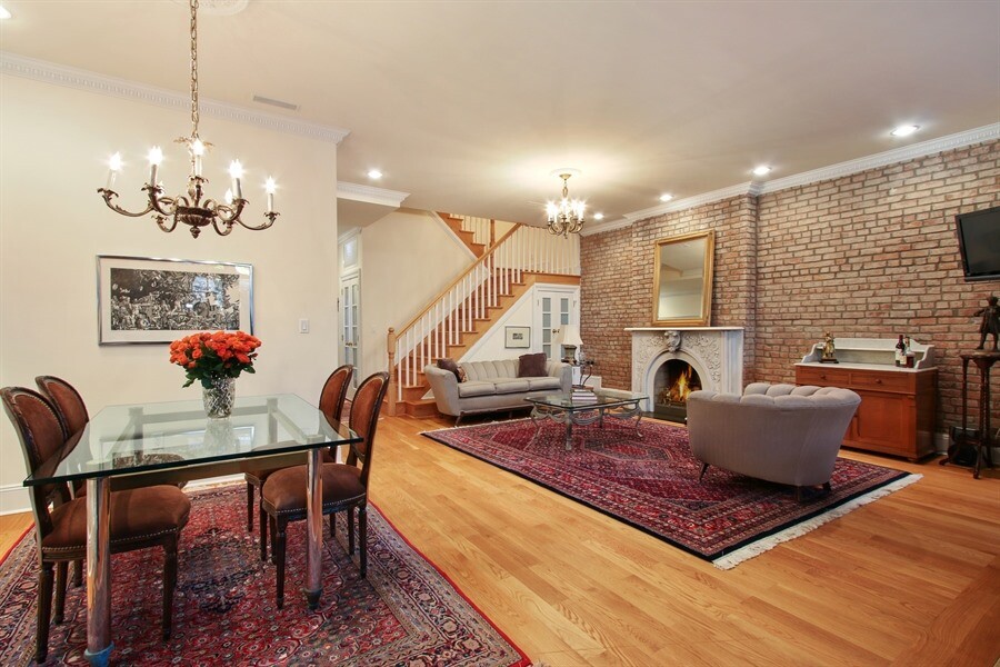 336 West 23rd Street Manhattan, NY 10011 - Photo 13 of 29 a living room with furniture a fireplace and a chandelier