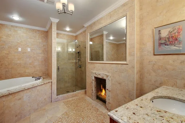 a living room with furniture a fireplace and a chandelier