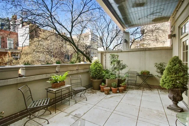 a large kitchen with kitchen island granite countertop a large counter top stainless steel appliances a stove a sink and cabinets