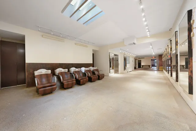 a spacious bedroom with a large bed and a large window