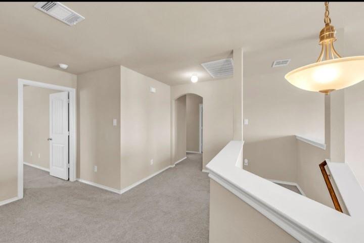 2315 Julia Lane Forney, TX 75126 - Photo 12 of 35 Hallway with arched walkways and light carpet