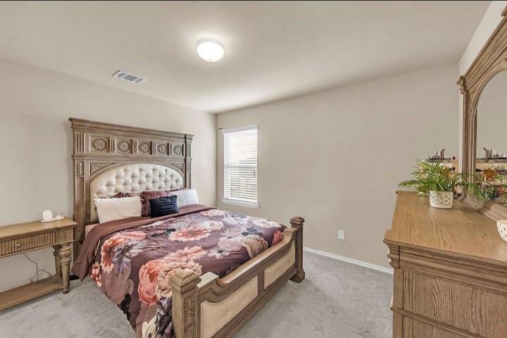 2315 Julia Lane Forney, TX 75126 - Photo 15 of 35 Bedroom with light colored carpet and baseboards